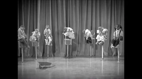 1937 - A costumed monkey roller-skates with a wheelbarrow and another monkey Stock Footage 84329646