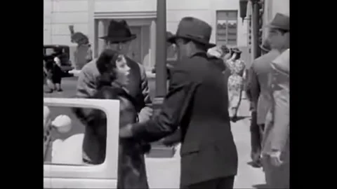 1937 - In this drama, two men roughly pull a woman out of her car and manhandle Stock Footage 226601089