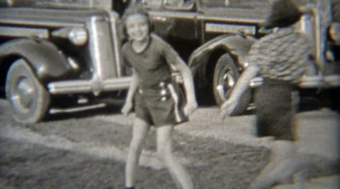 1937: Girls Rollerskating on Sidewalks in Elyria, Ohio Stock Footage 55742884