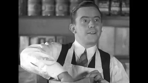1937 - People in daily life activities talking about the new Chevrolet. Stock Footage