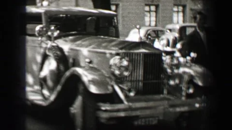 1937: Rolls-Royce Classic Car Marveled at by Men at Elite Castle Villa in Stock Footage 63564682