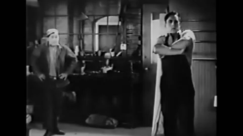 1938 - In this silent comedy, two friends are roleplaying husband and wife and Stock Footage 232882949