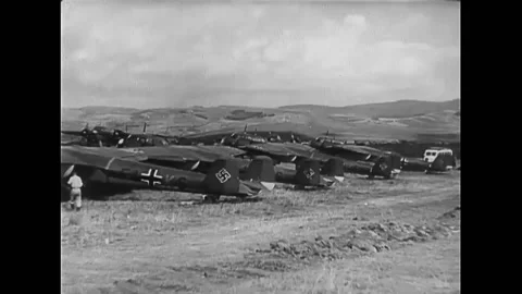 1939 - Luftwaffe airmen unload bombs and ammunition for planes on a Polish Stock Footage 248326453