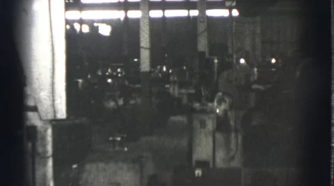 1939: men at work in spacious factory where heavy equipment is in use and safety Stock Footage