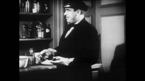 1939 - In this Sci-Fi horror serial, a man drops a coin in a lab and a spider Stock Footage 218365815