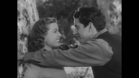 1940 - In this comedy, a man holds both hands of a woman and kisses her. She Stock Footage 221854806