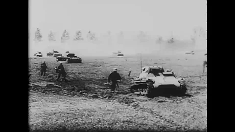 1940 - The Panzer Division advances across a French battlefield. Stock Footage 109551815