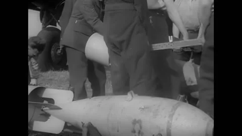 1940 - RAF airmen load bombs through the bomb bay door of an aircraft. Stock Footage 164593300