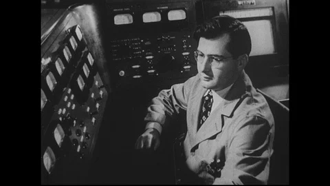 1940s-1950s : A scientist works in the control room of a cyclotron. Stock Footage