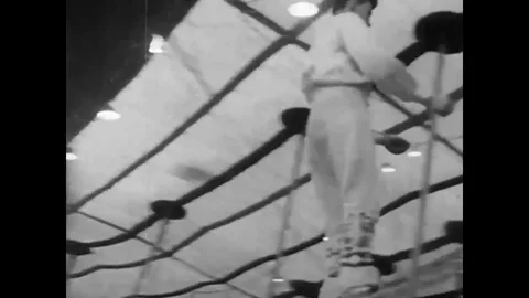 A 1940?s, 3 ring circus act features bareback riders, acrobats and clowns doing Stock Footage 79518351