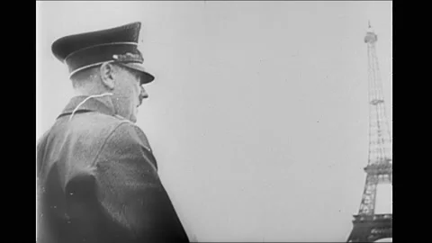 1940s: Adolf Hitler looking at Eiffel Tower. Audience lining street, watching Stock Footage 166398227