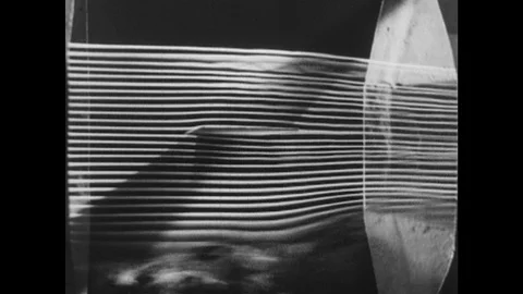 1940s: Air foil inside wind tunnel. Smoke streams in wind tunnel flow past air Stock Footage 118177924