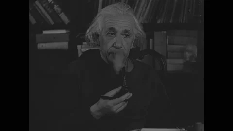 1940s: Alfred Einstein smokes pipe.  Enrico Fermi works in lab.  People on city Stock Footage 162761812