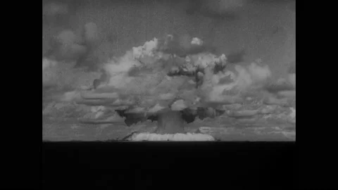 1940s: Atomic bomb explodes on Bikini Atoll. Atomic explosion cloud descends Stock Footage 159390423