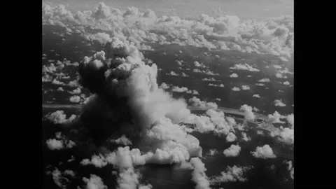 1940s: Atomic bomb explodes on Bikini Atoll. Observation ships sail around Stock Footage 159390447