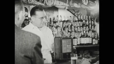 1940s: Bartender drops coin in juke box, plays "Has Anybody Here Seen Kelly?"; Stock Footage 194700618