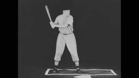 1940s: Baseball player at base, swinging bat. Tilt down player. Close up of Stock Footage 168263645