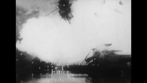 1940s: Battleship explodes / Planes fly overhead / Aerial view of Japanese 動画素材 74508055