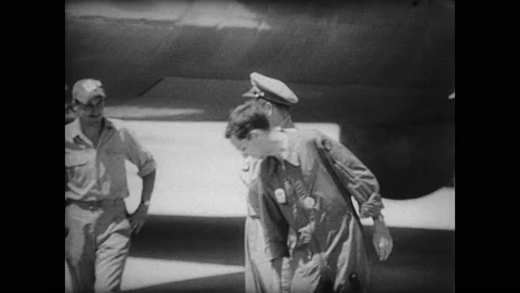 1940s Bikini Atoll: Bomber pilots stand near plane and talk to reporter on Stock Footage 138914227