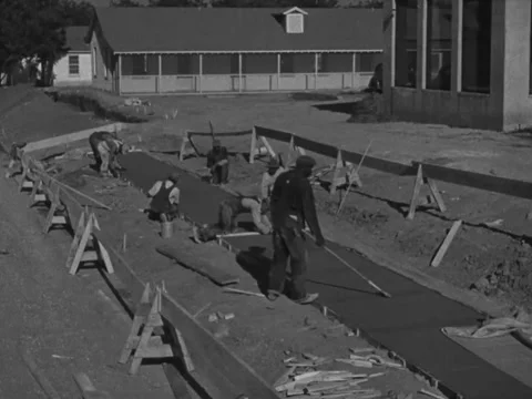 1940s: Black construction workers float cement Stock Footage 231813466