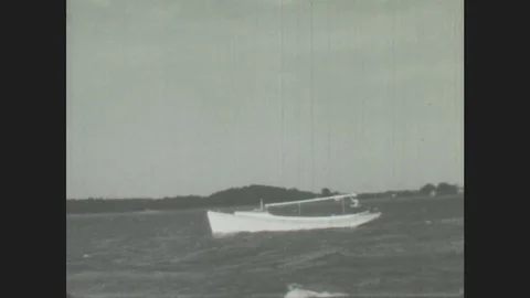 1940s: Boat on water, Man stands on boat Stock Footage