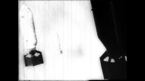 1940s: Bombs drop from plane. Bombs explode along coast. Battleships fire Video stock 89766587