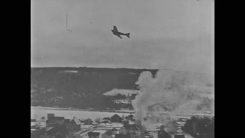 1940s: Bombs fall from German planes. Bombs drop and explode. Plane flying. Video stock 140892708
