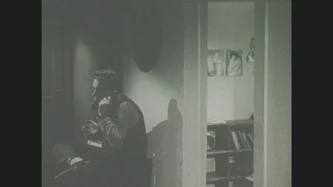 1940s: Boy talks on telephone, Lady eavesdrops Stock Footage