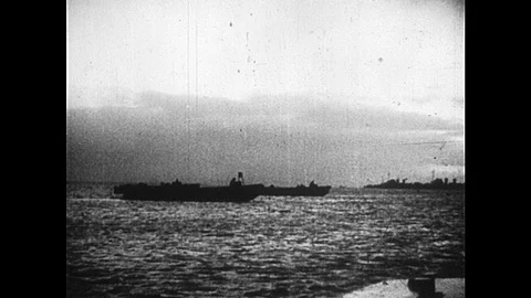 1940s: British naval ships float in ocean. Soldier waves semaphore flags. Men Video stock 91012786