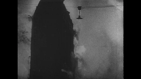 1940s: buildings collapse in fire. Flames from building. Fireman carries person Stock Footage