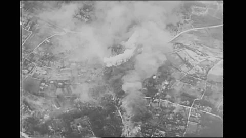 1940s: Buildings exploding. Rockets firing. Landscape exploding. Amphibious Stock Footage 164860535