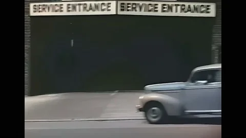 1940s - A camera fixed on a car is driven uphill on a busy street in San Stock Footage 173049942