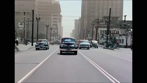 1940s - A camera fixed on a car is driven up a main street in Los Angeles, Stock Footage 173051560