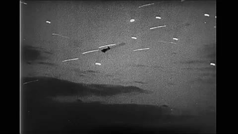 1940s: Cannon fire. Warship exploding. Flaming airplane. Airplane flying. Bomb Video stock 164860468