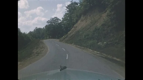 1940s: Car drives down different roads. Open landscapes Stock Footage