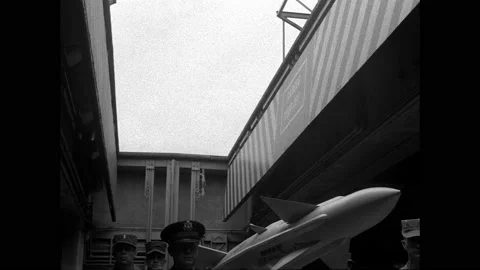 1940s: Ceiling panel opens, soldiers, officer and rocket raise up on lift 動画素材 158857949