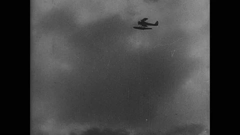 1940s China: Plane flies through the sky. Bombs land in water. Wounded soldiers Stock Footage 138337857