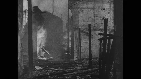1940s China: Planes drop bombs on city. People run. Buildings explode and burn. Stock Footage 143692438