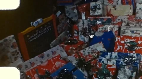 1940s Christmas presents under tree. Vintage 8mm Home Video. Stock Footage 253450382