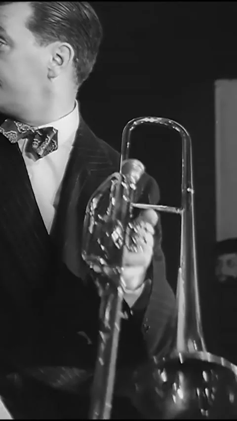1940s - Close-ups of the trombone and trumpet players performing in Eddie Stock Footage 287579554