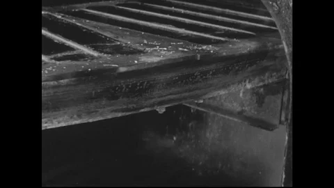 1940s: close up view of casting wheel. Cold water sprays on casting wheel. Stock Footage