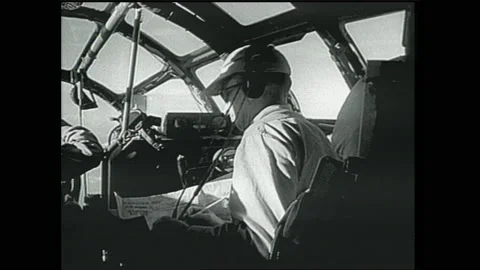 1940s: Command and bomber planes fly through sky. Soldiers plot course on map in Video stock 153551882