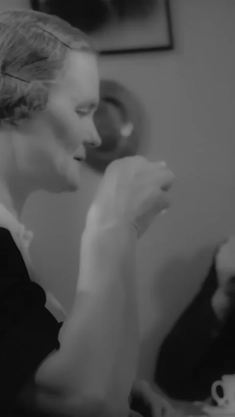 1940s - A couple drinks tea at home while an elderly relative knits. Video stock 287572012