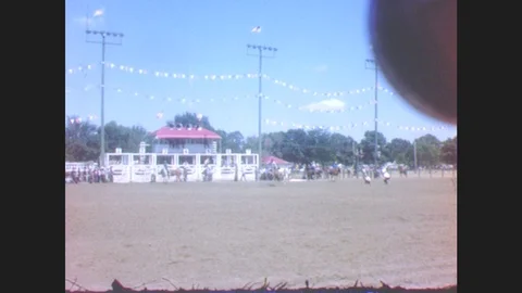 1940s: Cowboys riding bucking broncos at the rodeo. Cowgirls pose in colorful Stock Footage