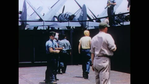 1940s: Crew rides the airplane elevator to the flight deck. The island of the Video stock 158438729