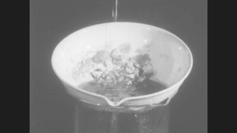 1940s: Crystals of solid matter on plastic rim of glass container. Crystals of Stock Footage 80382777