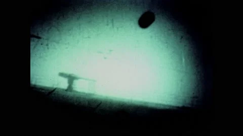 1940s: Depth charge sinks next to submarine underwater. Explosion on surface of Stock-Footage 133254833