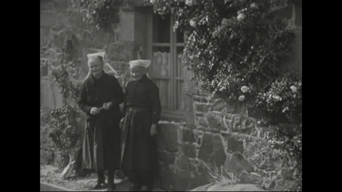 1940s: Elderly villagers admire initials on building, stroll to waterfront, 動画素材 156520271