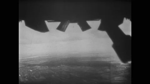 1940s ENGLAND: Bombs fall from planes. Parliament. Bomb shelter signage. People Vídeo Stock 140891647