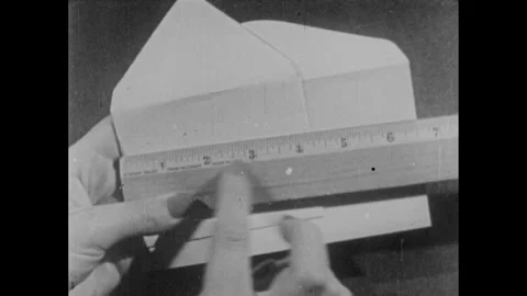 1940s: Envelope sizes being compared and measured. Woman opening a file on the Stock Footage 253354074